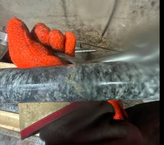 A person wearing gloves holding a pipe AI-generated content may be incorrect.